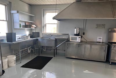 kitchen area, stove, prep tables, sink