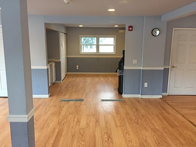 area looking towards area with microwave, closet, and garbage can